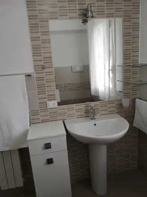 a small bathroom with a sink and a mirror at Casetta 