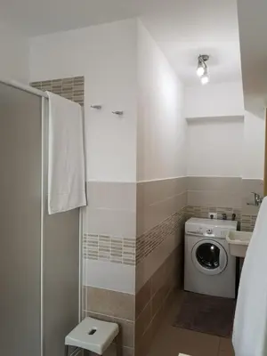 a bathroom with a washing machine and a sink at Casetta 