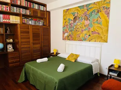 a spiral staircase in a living room with a wooden dresser at CASA DEL CORSO in Cinisi