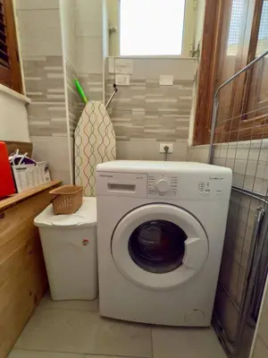 a laundry room with a washing machine and a toilet at Casa Kennedy in Capaci
