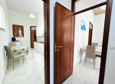 a door leading into a dining room with a table at Casa Kennedy in Capaci