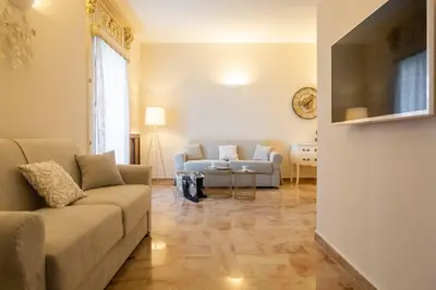 a living room with a couch and a table at Appartamenti Porto Antico La Cala in Palermo
