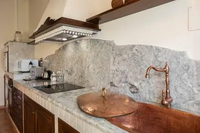 a kitchen with a sink and a counter top at Appartamenti Porto Antico La Cala in Palermo