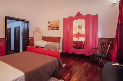 a bedroom with two beds and a mirror at Cinematocasa Suite in Palermo