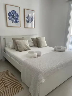 a large white bed in a white room at Cocciu d’amuri in Terrasini