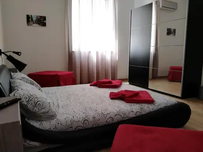 a bedroom with a bed with red towels on it at Olivuzza Serena in Palermo