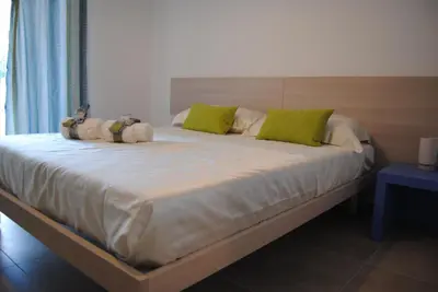 a large bed with two stuffed animals on it at Villa Edori - Giardino degli Allori in Castellammare del Golfo