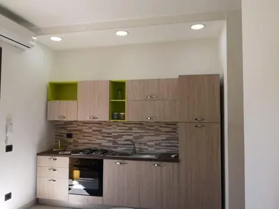 a kitchen with a sink and a stove and cabinets at Appartamento a San Vito lo capo in San Vito lo Capo