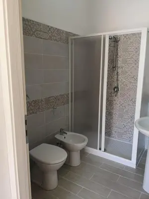 a bathroom with a toilet and a sink and a shower at Appartamento a San Vito lo capo in San Vito lo Capo