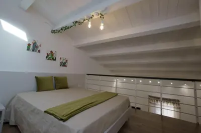 a bedroom with a bed in a white room at Stabile HolidayHome in Castellammare del Golfo