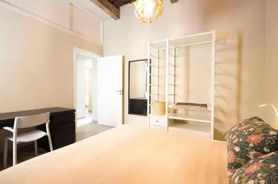 a bedroom with a bed and a desk and a chair at Casa dell'Architetto alla Cattedrale by Wonderful Italy in Palermo