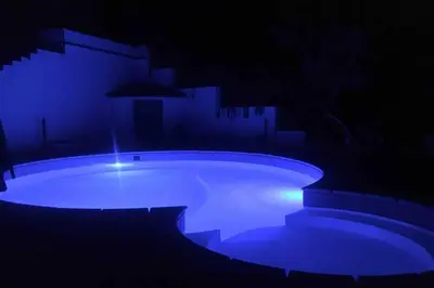 a swimming pool lit up in the dark at Gibilrossa BeeHill in Misilmeri