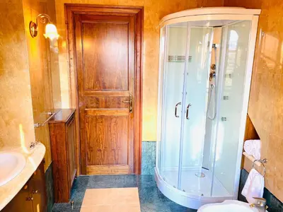 a bathroom with a shower and a toilet and a sink at Camera Vento Porto Antico La Cala in Palermo