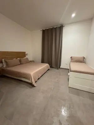 a bedroom with two beds and a window at Palermo Inn in Palermo