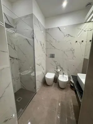 a bathroom with a shower and a toilet and a sink at Palermo Inn in Palermo