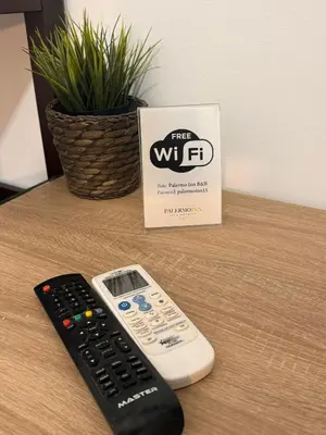 a remote control sitting on a table next to a box at Palermo Inn in Palermo