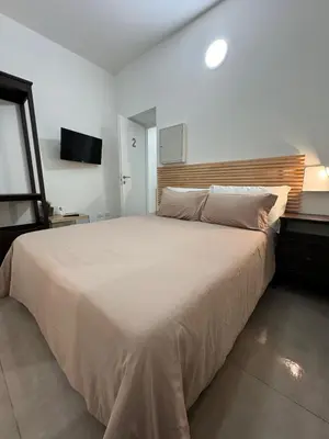 a bedroom with a large bed and a window at Palermo Inn in Palermo