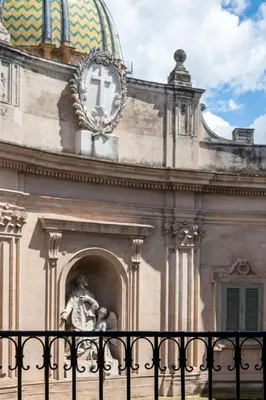 a building with a clock on top of it at Villena Plaza by Wonderful Italy in Palermo