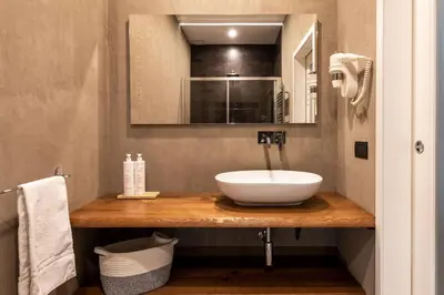 a bathroom with a sink and a mirror at Villena Plaza by Wonderful Italy in Palermo