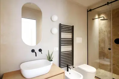 a bathroom with a sink and a toilet and a mirror at Pànto - Rooftop boutique rooms in Palermo