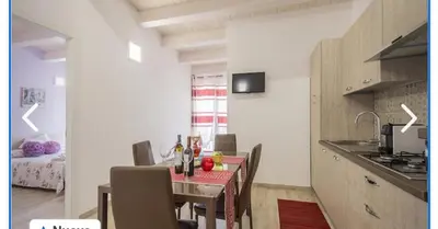 a kitchen and dining room with a table and chairs at Appartamento francy in Castellammare del Golfo