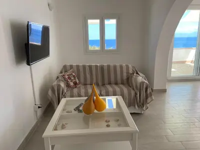 a living room with a couch and a table at Villa Costanza in San Vito lo Capo