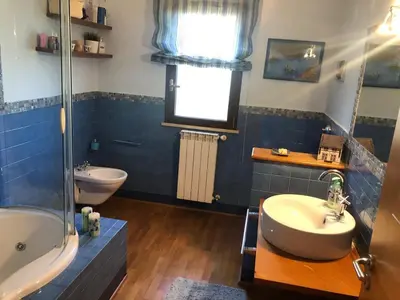 a bathroom with a sink and a tub and a toilet at Villa Tiziana in Monreale