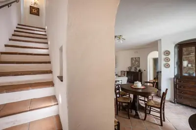 a kitchen and dining room with a table and stairs at Villa a 300 Mt. dal Mare (Magaggiari) con campo da tennis in Cinisi