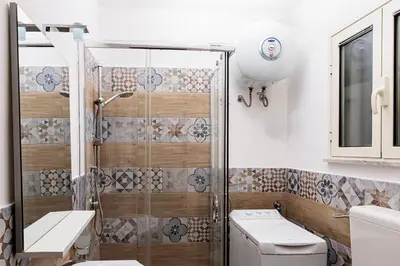 a bathroom with a shower and a toilet at Little House ai Tartari in Palermo