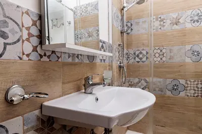 a bathroom with a sink and a mirror at Little House ai Tartari in Palermo