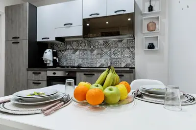 a bowl of fruit on a table in a kitchen at Little House ai Tartari in Palermo