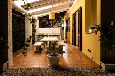 a patio with a table and a potted plant at Villa Bienvenue in Carini