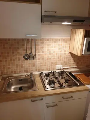 a kitchen with a stove top and a sink at Suite Cathedral Palermo in Palermo