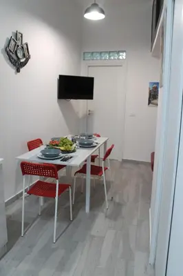 a dining room with a white table and chairs at Rigoletto Holiday Home,Centrocittà Palermo in Palermo