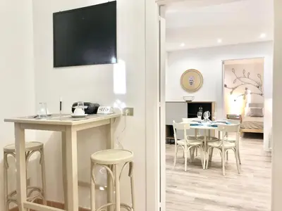 a kitchen and dining room with a table and chairs at SUITE 4 CANTI in Palermo