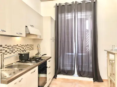 a kitchen with a sink and a shower curtain at SUITE 4 CANTI in Palermo