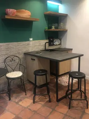 a kitchen with two chairs and a table and a counter at ne mia in Palermo
