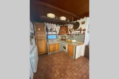 a kitchen with a sink and a stove top oven at A casa di Eugenio in Carini