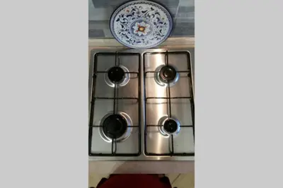 a stove top with a plate on top of it at Isabella house in Casteldaccia