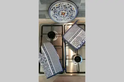 a stove top with two plates and a bowl at Isabella house in Casteldaccia
