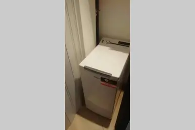 a small refrigerator in a corner of a room at Isabella house in Casteldaccia