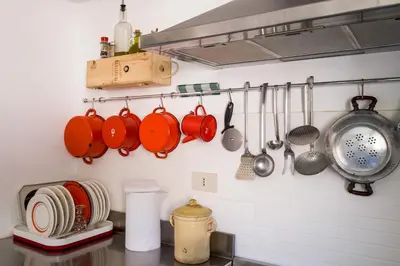 a kitchen with utensils hanging on a wall at Surplus Charming Apartment in Palermo
