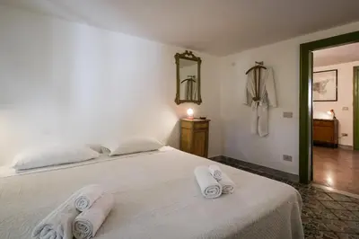a bedroom with a white bed with towels on it at Surplus Charming Apartment in Palermo