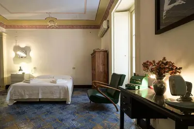 a bedroom with a bed and a table and chairs at Casa Particular Luxury in Palermo