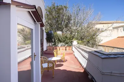 a patio with two chairs and a table on a balcony at Casa Particular Luxury in Palermo