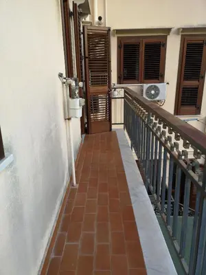 a hallway with a stairway leading to a door at La Casetta della Musica in Mondello