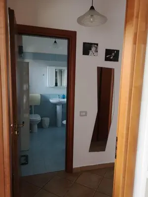 a bathroom with a mirror and a sink and a toilet at La Casetta della Musica in Mondello