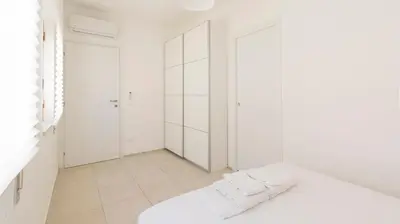 a bedroom with white walls and a white bed at Visitsicilia Azzurra Mare in Alcamo Marina