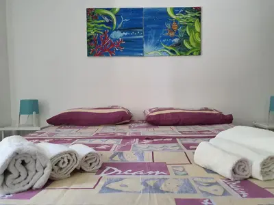 a room with towels on a floor with a painting at Alle Porte del Capo in Palermo