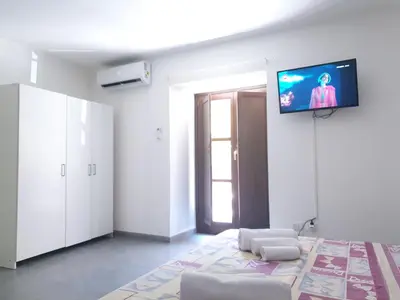a living room with a flat screen tv on the wall at Alle Porte del Capo in Palermo